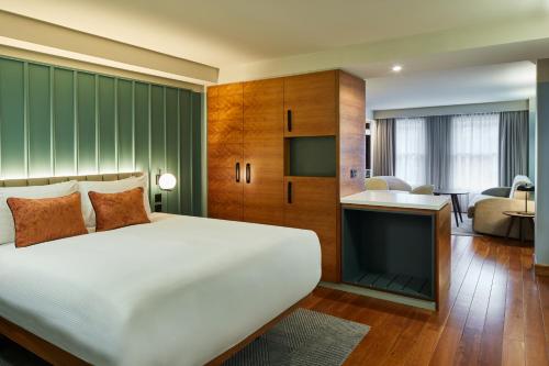 a bedroom with a white bed and a living room at master Farringdon in London