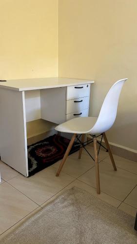 a white desk with a chair next to a desk at Shalom Apartments Utawala near JKIA Airport in Nairobi