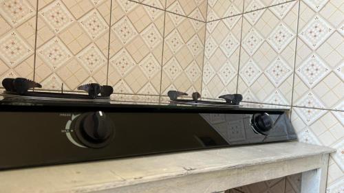 a black microwave sitting on a counter in a room at Shalom Apartments Utawala near JKIA Airport in Nairobi