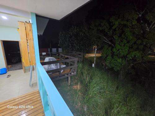 a porch with a bench on a deck at night at Talii Sasa Accommodation in Langgere