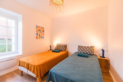 a bedroom with two beds and a window at Ar Pazenn - Découverte de la côte de granit rose in Plouguiel