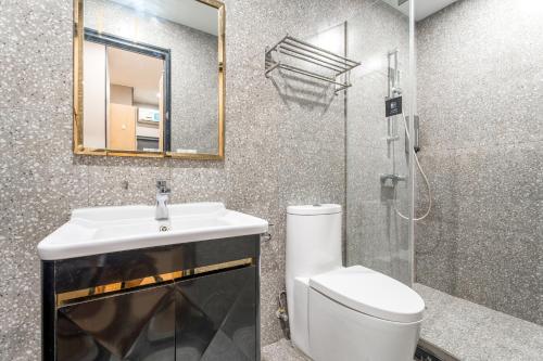 a bathroom with a toilet and a sink and a shower at Meego Yes Hotel in Shanghai