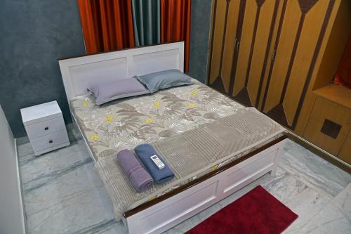 a small bed with two pillows on top of it at Royal Residency 3BHK -II in Kondapur