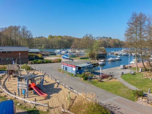 a view of a marina with a playground and boats at Zimmer am See - 02 in Eldenburg