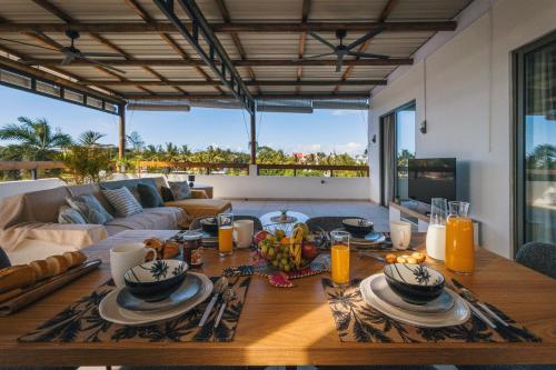 a living room with a table and a couch at Cozy Penthouse - Near restaurants and beaches in Grand Baie