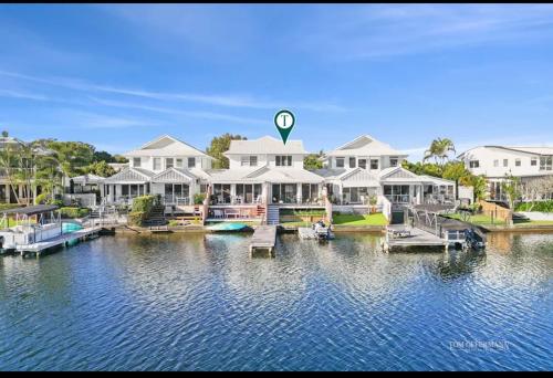 a group of houses on the water with a dock at Noosa Waters Retreat in Noosaville