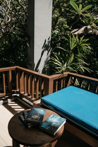 a bed sitting on a porch with a table at Sand Sea Resort Railay Beach in Railay Beach