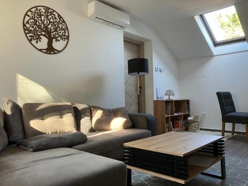 a living room with a couch and a coffee table at Borostyán Vendégház - Zalaegerszeg in Zalaegerszeg
