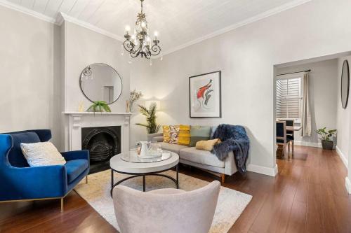 a living room with a couch and a table at Perfect Vacation Home w Large Outdoor Space in Sydney