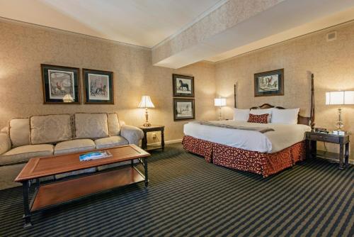 a hotel room with a bed and a couch at The Brown Hotel in Louisville