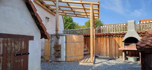 a wooden patio with a wooden gate and a fence at Chalupa Pod třešní in Desov