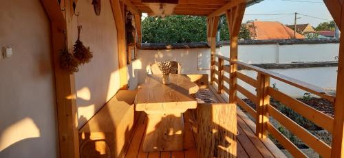 a wooden porch with a bench on a balcony at Chalupa Pod třešní in Desov