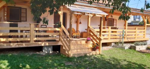 a house with a wooden staircase leading to a porch at Chalupa Pod třešní in Desov