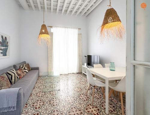 a living room with a couch and a table at Casa Trajano Grupo AC Gestion in Cádiz