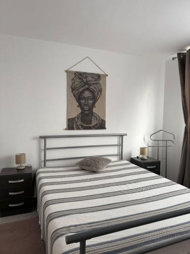 a bedroom with a bed with a statue on the wall at City Comfort Apartment in Bacău