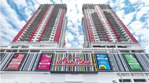 two tall white buildings with colorful signs on them at Cheap! 1-6pax Sunway Subang Mall & LRT Convenience in Subang Jaya