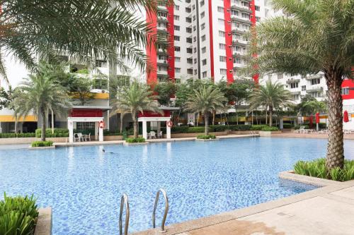 a large swimming pool with palm trees and buildings at Cheap! 1-6pax Sunway Subang Mall & LRT Convenience in Subang Jaya