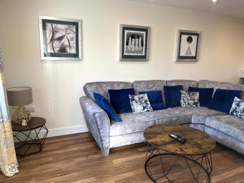 a living room with a gray couch and blue pillows at Campbell House in Lincoln