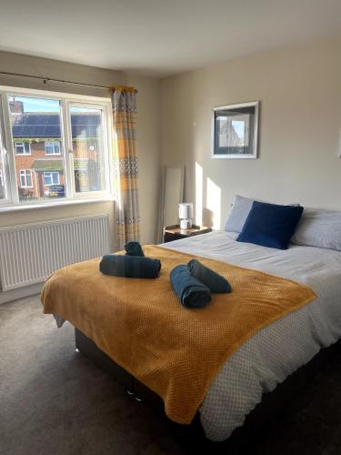 a bedroom with a bed with two towels on it at Campbell House in Lincoln
