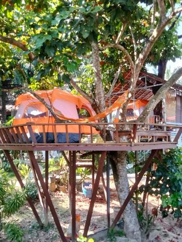 a tree house with an orange tent in a tree at Rommai Forest Bungalows in Ko Lanta