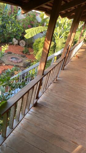 a wooden walkway leading to a pond in a garden at Berry homestay 1 in Buon Ma Thuot