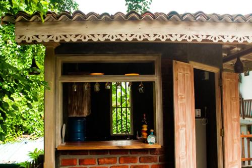 a porch with a window and a brick wall at Hide Surf Hostel Madiha in Matara