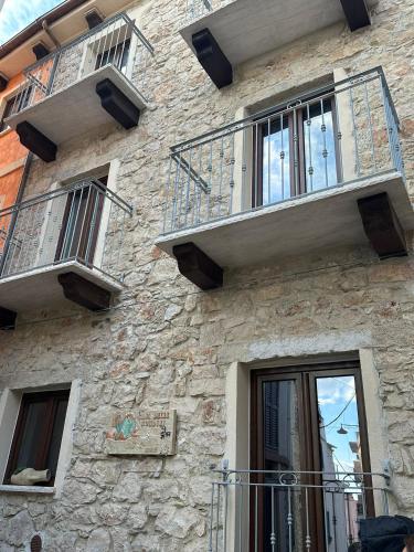 a stone building with balconies on the side of it at La Casa delle Rondini in Baunei