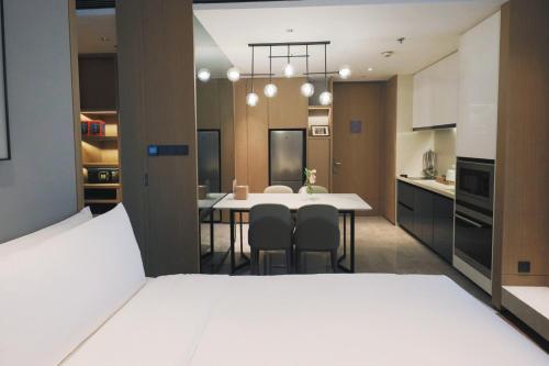 a kitchen and dining room with a table and chairs at The Meixi Lake, Changsha Marriott Executive Apartments in Changsha