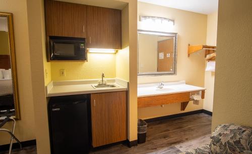 a small bathroom with a sink and a mirror at Coratel Inn and Suites By Jasper River Falls in River Falls