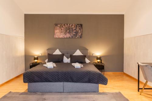 a bedroom with a large bed with two lamps at Wellness Home I Sauna I Jacuzzi I Gasgrill in Sassenberg