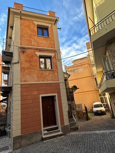 a building with a door on a street at La Casa delle Rondini in Baunei