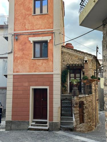 a building with a door and a staircase on it at La Casa delle Rondini in Baunei
