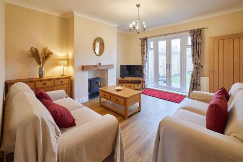 a living room with two white couches and a television at Host & Stay - Wardman Crescent in Redcar