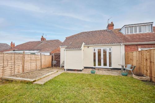 a backyard of a house with a wooden fence at Host & Stay - Wardman Crescent in Redcar