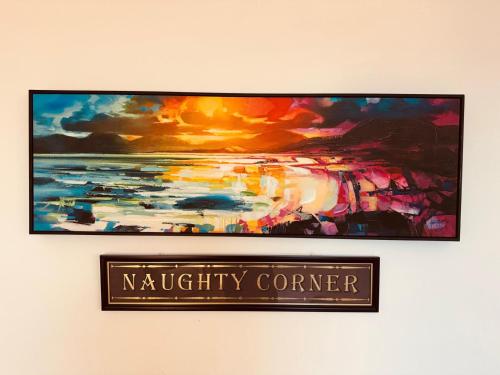 a painting on a wall with a sign on it at Lola's Loft with Lake Views - Central Bowness - Pet Friendly in Bowness-on-Windermere