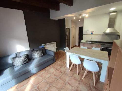 a kitchen and dining room with a table and chairs at Aula Natura La Salle - Cal Cerdanyola in Bagá