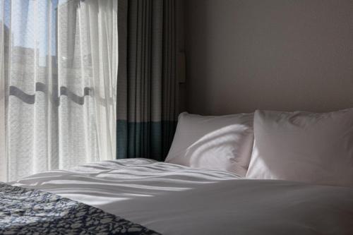Postel nebo postele na pokoji v ubytování yksi STAY ＆ APARTMENT OSAKA