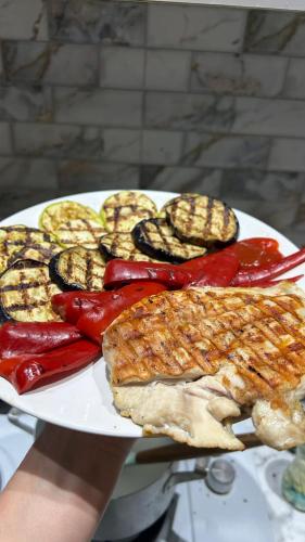 a plate of food with meat and vegetables on it at Green bunny ArtHouse in Martvili
