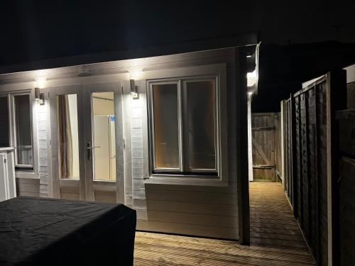 a small room with a door and a window at The Grove self-contained Garden Suite in Bexleyheath
