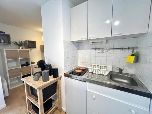 eine Küche mit Spüle und Arbeitsplatte in der Unterkunft Charming T1 - Parking - Metro St Agne in Toulouse