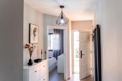 a room with a bed and a hallway with a door at Mandarina 326 in San Miguel de Abona