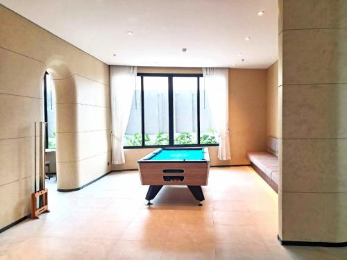 a room with a pool table in front of a window at Viewpoint Khaoyai Hotel in Mu Si