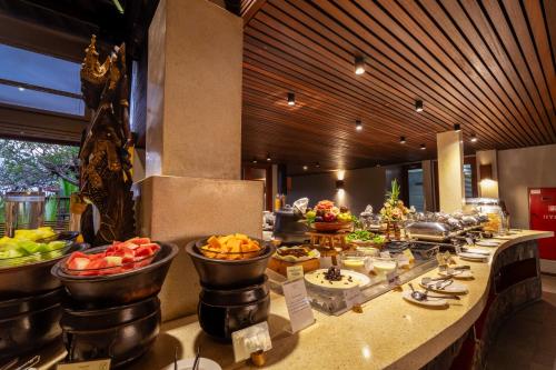 a buffet line with fruits and vegetables in a hotel at Mercure Kuta Bali in Kuta