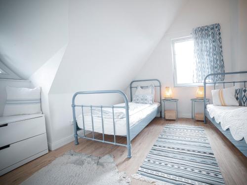 a bedroom with two bunk beds and a window at Ferienhaus Emma in Kramerhof