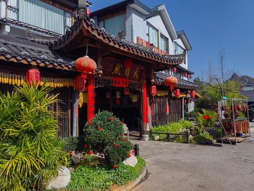 an asian building with red lanterns in front of it at Serene Vale Inn Railway station free pick-up by 2 nights English and Spanish reception available in Guilin