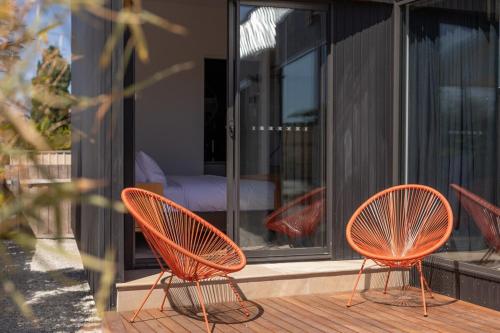 two orange chairs sitting on a deck on a house at Old Charm Meets New in Perth