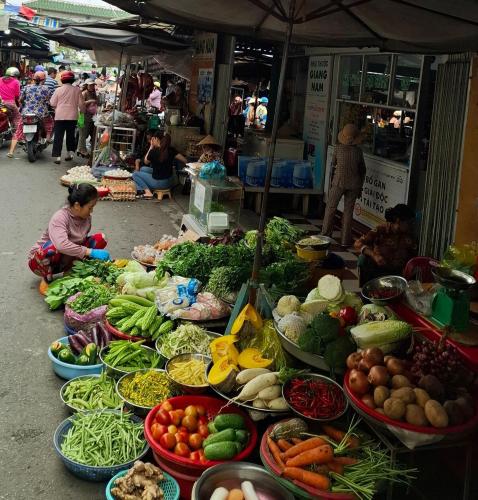a market with lots of fruits and vegetables on display at dove home - barn, bird, chicken, sunshine, flower, paceful in Cái Răng