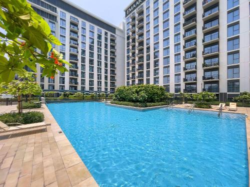 a large swimming pool with two tall buildings at Premium Apartments at Executive Residences in Dubai