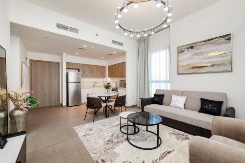 a living room with a couch and a table at Premium Apartments at Executive Residences in Dubai