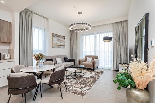 a living room with a couch and a table and chairs at Premium Apartments at Executive Residences in Dubai